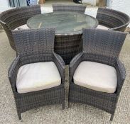 A rattan garden set to include two arm chairs, round table and four curved seats with cushions (