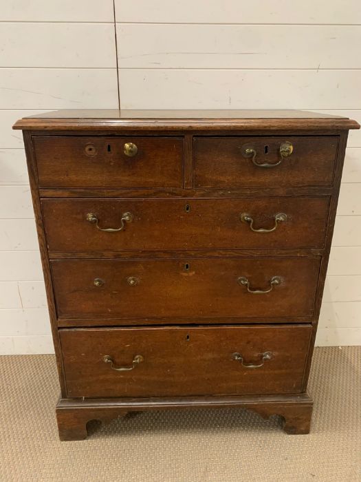 A George III style mahogany chest of drawers with brass swan neck drop handle, bracket feet (