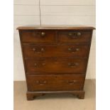 A George III style mahogany chest of drawers with brass swan neck drop handle, bracket feet (