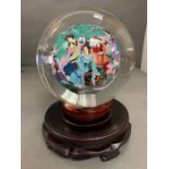 A hand painted oriental theme reverse painted glass paper weight globe with stand