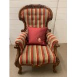 A Rococo style carved open armchair in striped upholstery, button back.