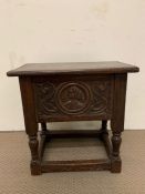 An oak carved stool with hinged top opening to storage (52cm x 30 cm x 52cm)