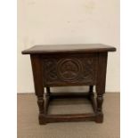 An oak carved stool with hinged top opening to storage (52cm x 30 cm x 52cm)