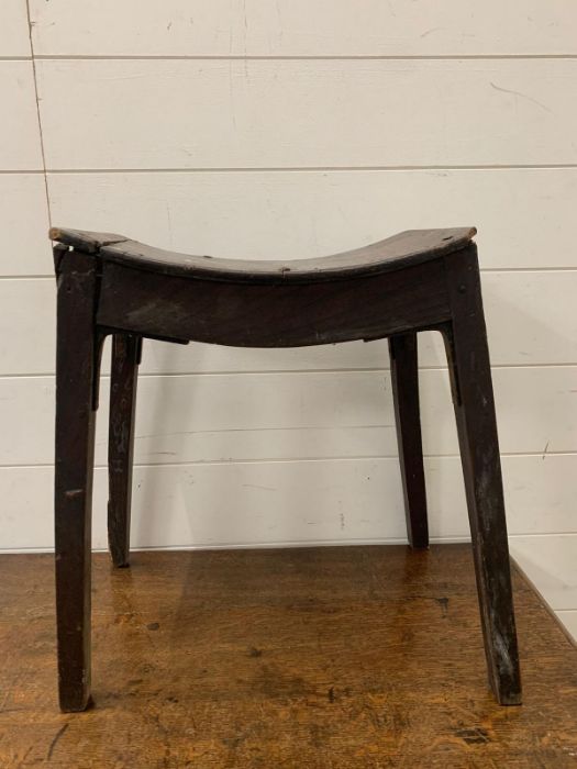 A wooden work stool on shaped seat and tapering legs AF (H44cm W39cm)