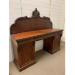 A mahogany pedestal sideboard, the raised back with scroll and foliage carving three drawers above