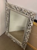 A carved wall mirror (77cm x 97cm)