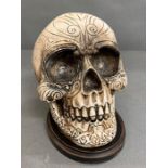 A decorative skull ornament on plinth