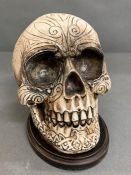 A decorative skull ornament on plinth