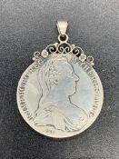 A Maria Theresa thaler, silver bullion on a pendant mount.