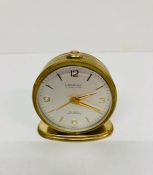 A Vintage Looping 15 jewel lever 8 day antimagnetic travel clock