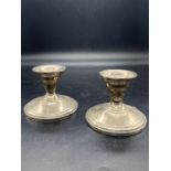 A pair of Sterling silver squat candlesticks