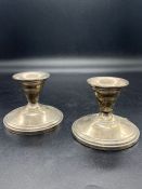 A pair of Sterling silver squat candlesticks