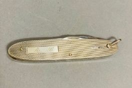 A silver pen knife, machine tooled decoration.