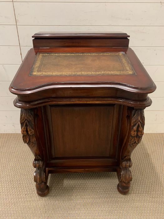 A Reproduction Davenport desk, hinged sloping top opening to drawers on two turned supports.