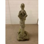 Garden stone figure of a boy playing flutes, seated. H 90 cm