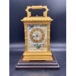 A Late 19th Century French gilt-brass and painted porcelain carriage clock (H 17cm) On a wooden