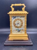 A Late 19th Century French gilt-brass and painted porcelain carriage clock (H 17cm) On a wooden