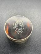 A silver and tortoiseshell pill box