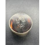 A silver and tortoiseshell pill box