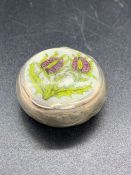 A hallmarked silver thistle decorated pill box