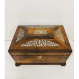 A work box decorated with inlaid mother of pearl.