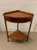 A corner table with drawer to centre and dummy drawers to sides (H79cm W58cm)