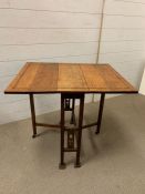 An arts and craft table with drop sides (H60cm W69cm D56cm)