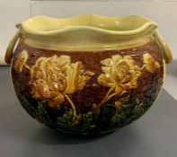 A jardinière pot with yellow and brown grounds