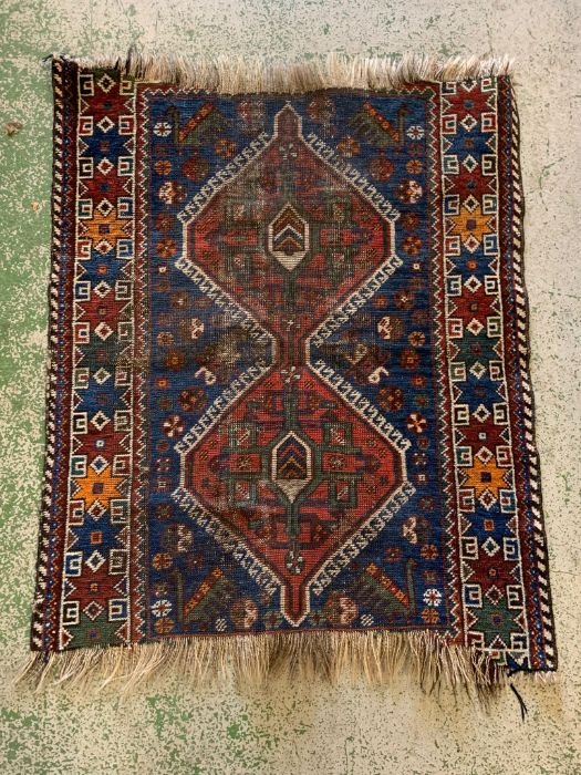 A Persian Hamadan carpet with two centre medallions (100cm x 82cm)