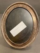 An oval silver picture frame by A & J Zimmerman Ltd (Arthur & John Zimmerman) hallmarked for