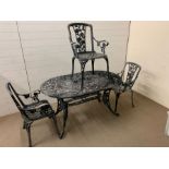An oval metal garden table with three matching chairs (W 140 cm x D 84 cm x H 75cm)