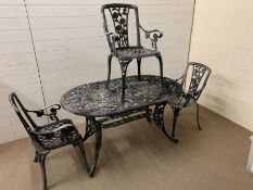 An oval metal garden table with three matching chairs (W 140 cm x D 84 cm x H 75cm)