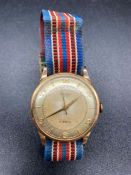 A Rotary UM 17 Jewels 9ct gold Gents watch on a fabric strap (Total Weight 22.3g)