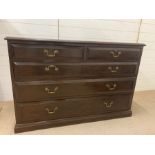 An Oak chest of drawers with two short and three graduated drawers and brass handles (H 84 cm x D