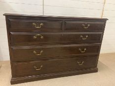 An Oak chest of drawers with two short and three graduated drawers and brass handles (H 84 cm x D