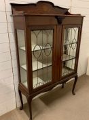 A mahogany display cabinet with lead and glazed doors on cabriole legs (H165cm W106cm D37cm)