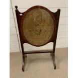 An inlay mahogany fire screen with needlework oval inset AF (76cm x 45cm)