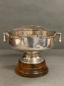 A Silver two handled rose bowl on a wooden stand, with an inscription from 1955. Hallmarked for