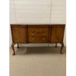A regency style sideboard flanked by cupboards to end and drawers to centre (H94cm W152cm D56cm)