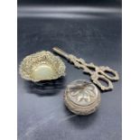 Three white metal items to include grape scissors, pierced pin dish, and a cockerel finial pot.