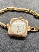 A 9ct gold watch, on a rolled gold strap