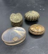 Four white metal pill boxes of various designs