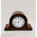 A small mahogany Napoleon mantle clock
