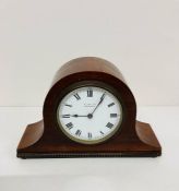 A small mahogany Napoleon mantle clock