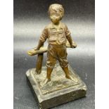 A Bronze figure of a boy, signed to base ( 10.5cm H)