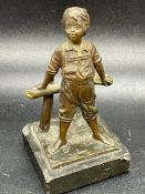 A Bronze figure of a boy, signed to base ( 10.5cm H)