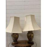 A pair of ginger jar style table lamps decorated with wistra and birds