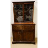 A George III style secretaries chest, fall front enclosing a fitted interior of drawers and pigeon