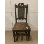 A carved wooden hall chair