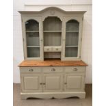 A painted Welsh dresser with glazed doors and cupboards below (H205cm W153cm D62cm)